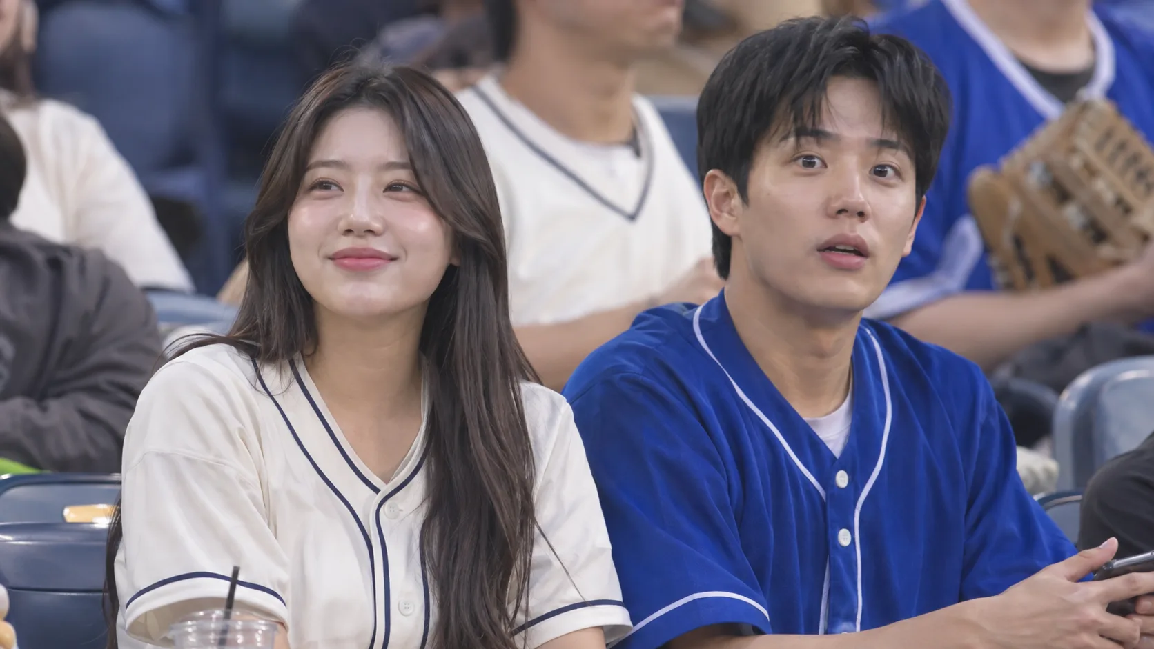 AI-generated pair of friends seated together in a baseball stadium crowd