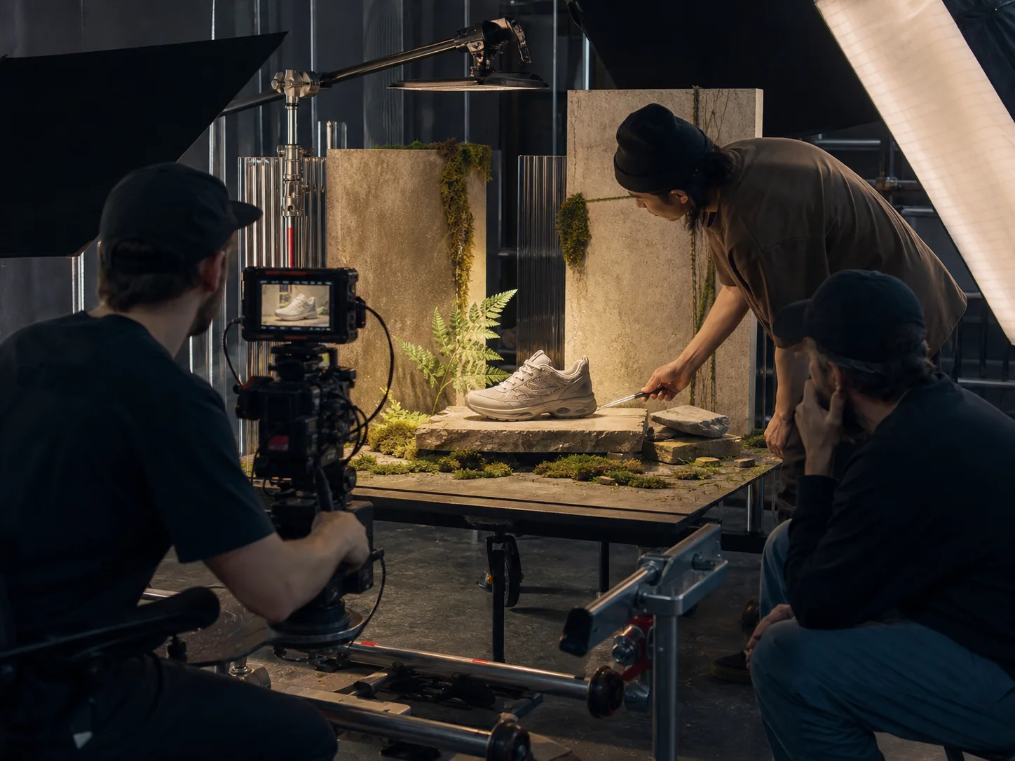 A product commercial crew filming a sneaker on a practical studio set