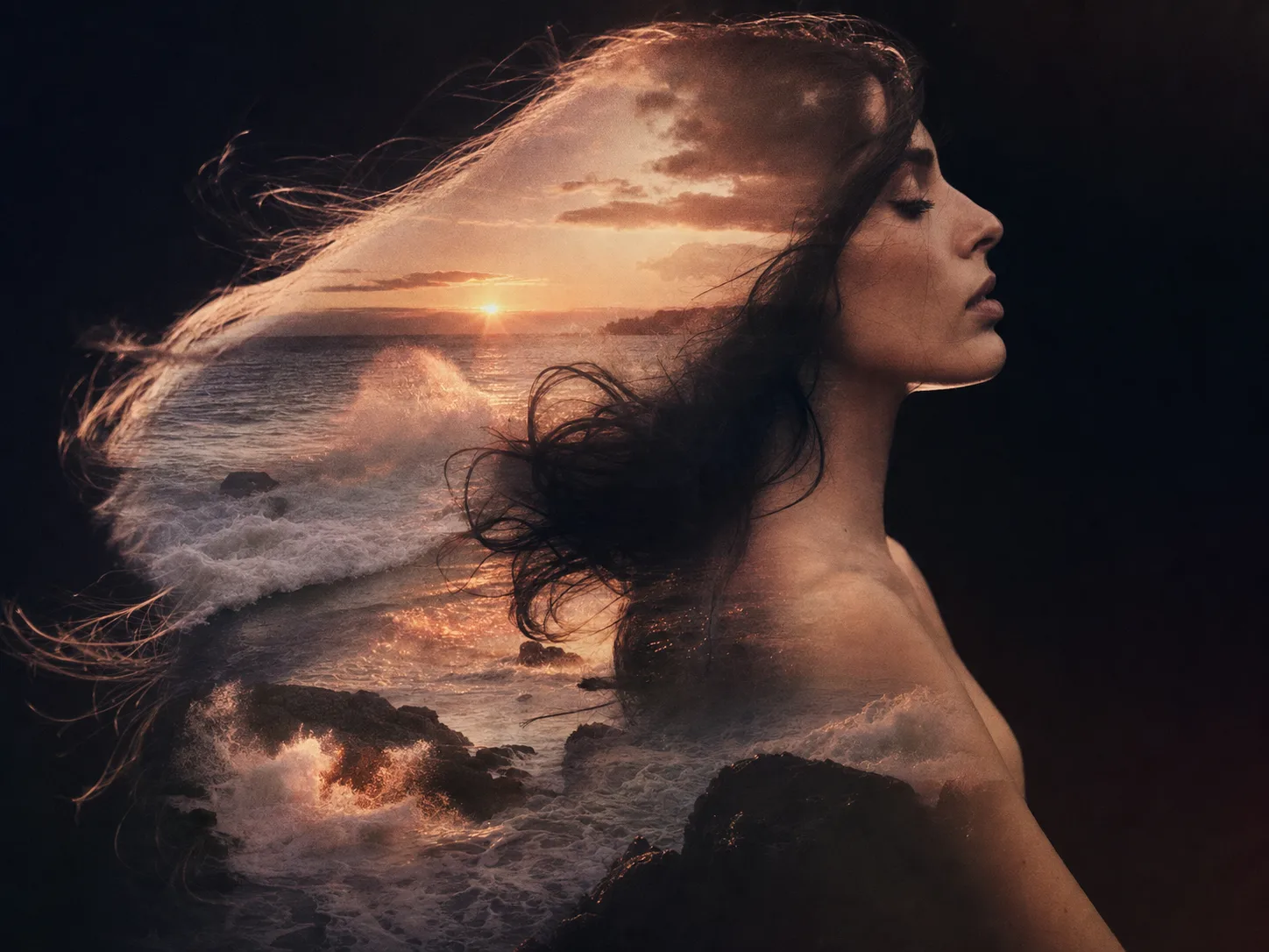 A double-exposure portrait of a woman's profile blended with crashing ocean waves at sunset