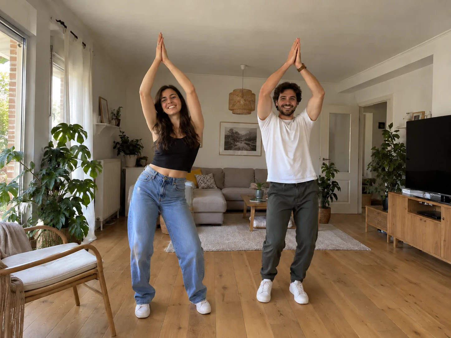 A couple in a bright living room throwing their arms up overhead in a clap and grinning at the camera, a Mi Chico couple dance made with AI