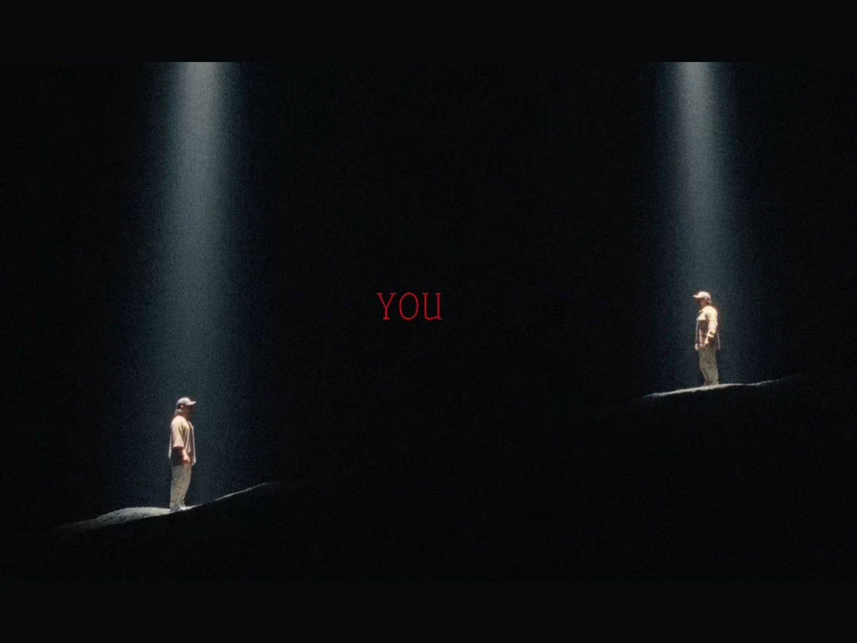 Two versions of the same person facing each other on separate slopes beneath spotlights with the word YOU between them